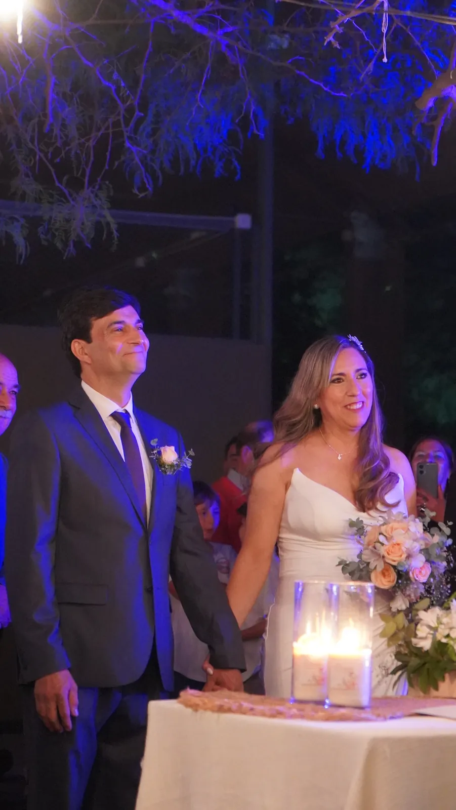 Novios en la ceremonia bajo el árbol iluminado